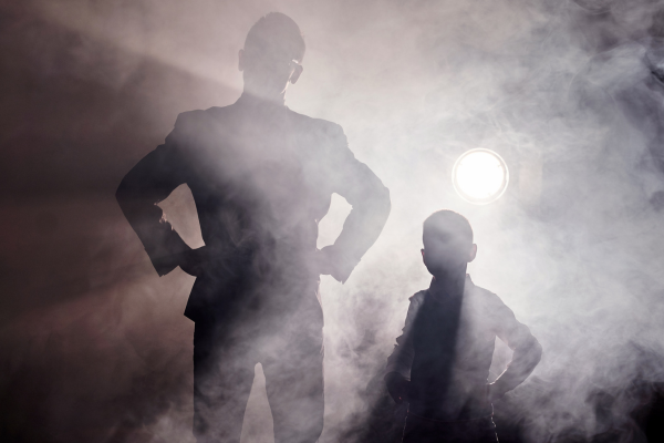 two men shown in silhouette
